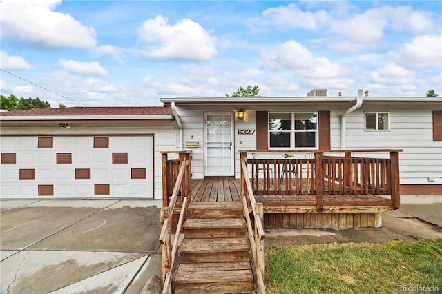 6327 Fenton St, Arvada, CO 80003 - view of front of property with a garage, a porch, and driveway