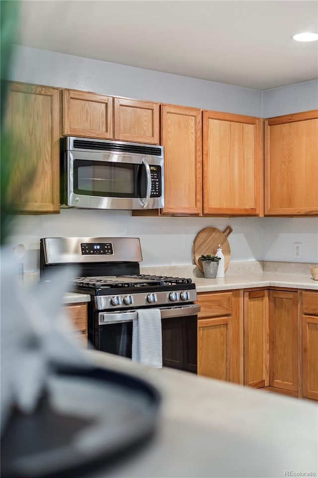6327 Fenton St, Arvada, CO 80003 - kitchen with stainless steel appliances and light countertops