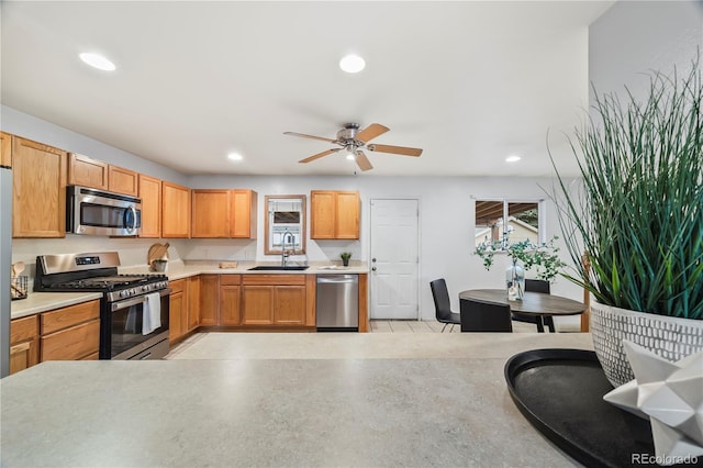 6327 Fenton St, Arvada, CO 80003 - kitchen with appliances with stainless steel finishes, healthy amount of natural light, recessed lighting, light countertops, and ceiling fan