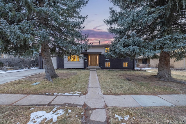 obstructed view of property with a lawn