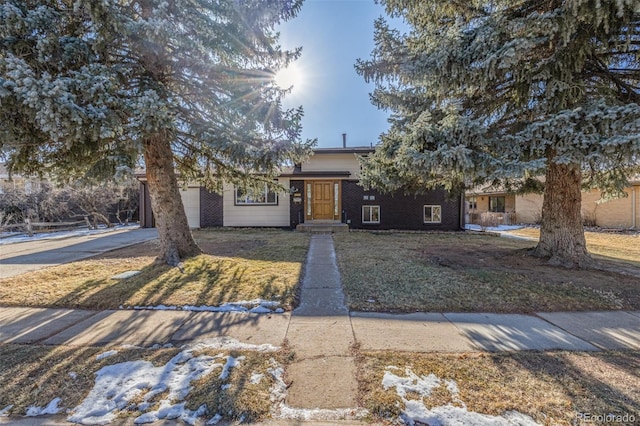 view of front facade with a garage and a front yard