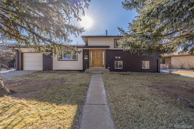 view of front of home with a garage and a front lawn