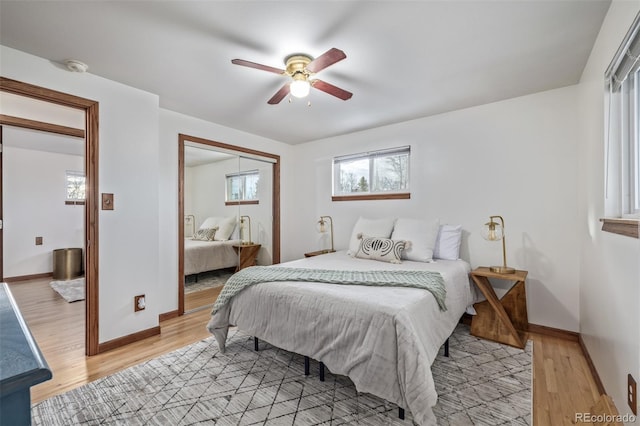 bedroom featuring ceiling fan, light wood-type flooring, and a closet