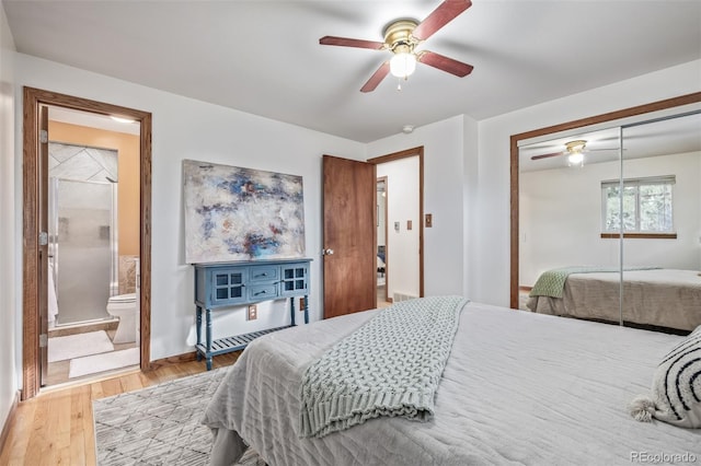 bedroom featuring ceiling fan, ensuite bathroom, hardwood / wood-style floors, and a closet