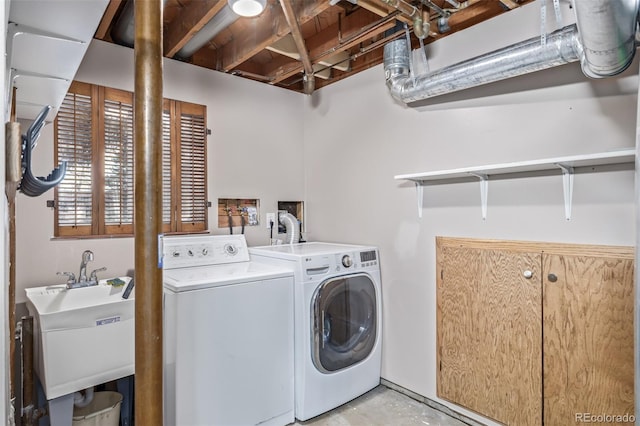 clothes washing area featuring washer and dryer and sink