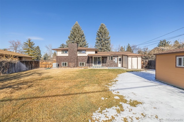 back of house featuring an outdoor structure, a yard, cooling unit, and a patio area