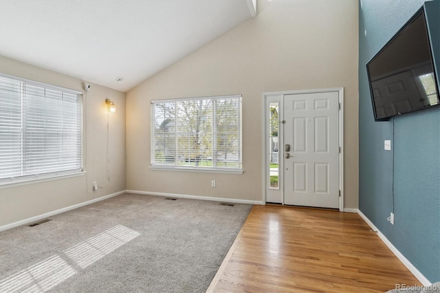 10517 Madison St, Thornton, CO 80233 - foyer entrance with plenty of natural light, baseboards, high vaulted ceiling, and light wood-type flooring