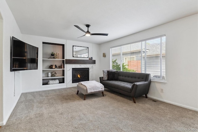 10517 Madison St, Thornton, CO 80233 - carpeted living area with a ceiling fan, a high end fireplace, and baseboards