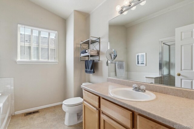 10517 Madison St, Thornton, CO 80233 - bathroom with tile patterned floors, toilet, a bath, vanity, and vaulted ceiling