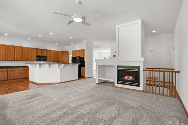 14447 Inca Ct, Westminster, CO 80023 - unfurnished living room featuring recessed lighting, a ceiling fan, a large fireplace, light colored carpet, and baseboards