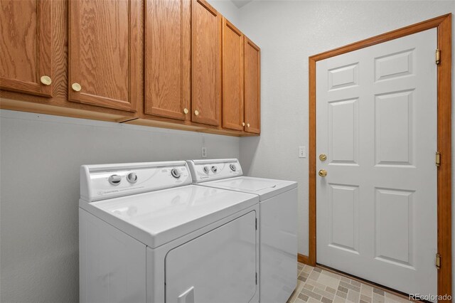 14447 Inca Ct, Westminster, CO 80023 - laundry room featuring washing machine and clothes dryer, cabinet space, and baseboards