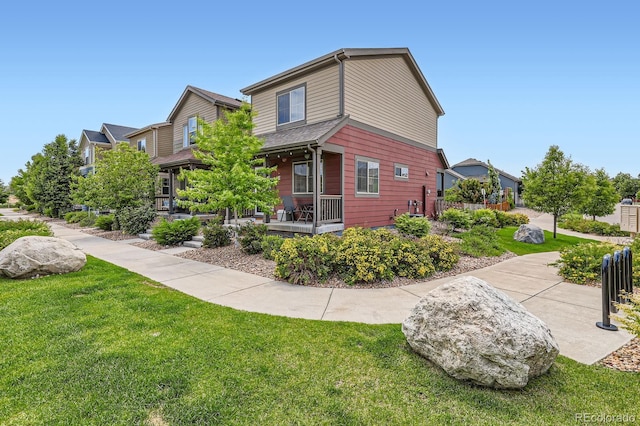 1199 Hummingbird Cir, Longmont, CO 80501 - view of front facade with a front lawn and covered porch