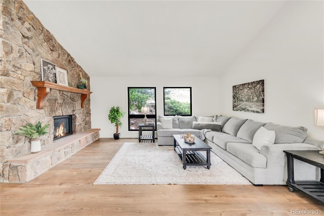 3260 Bit Rd, Evergreen, CO 80439 - living area featuring high vaulted ceiling, a fireplace, and wood finished floors