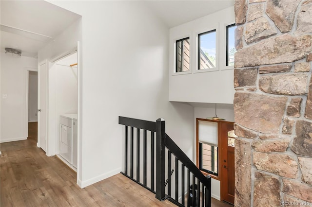 3260 Bit Rd, Evergreen, CO 80439 - hall featuring an upstairs landing, wood finished floors, washing machine and clothes dryer, and lofted ceiling