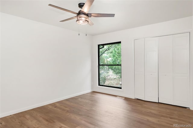 3260 Bit Rd, Evergreen, CO 80439 - unfurnished bedroom featuring wood finished floors, ceiling fan, and a closet