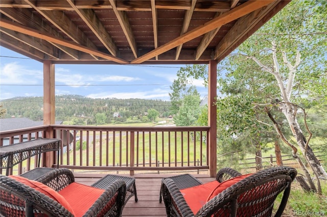 3260 Bit Rd, Evergreen, CO 80439 - wooden deck featuring a wooded view