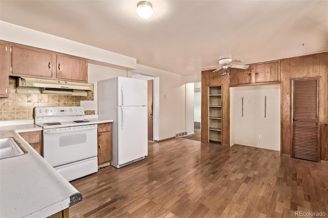 3182 W Radcliff Dr, Englewood, CO 80110 - kitchen with white appliances, under cabinet range hood, light countertops, and decorative backsplash