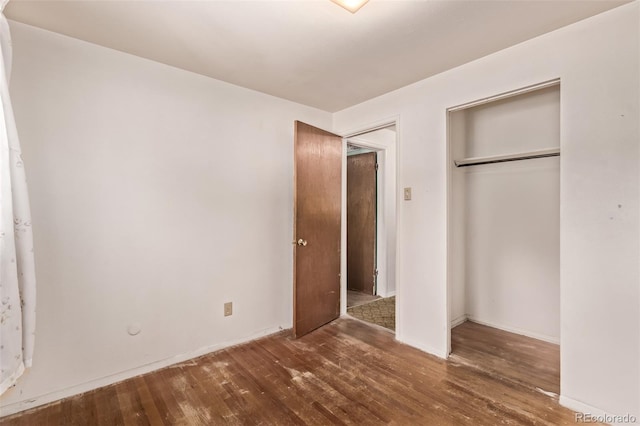 3182 W Radcliff Dr, Englewood, CO 80110 - unfurnished bedroom with wood finished floors, a closet, and baseboards