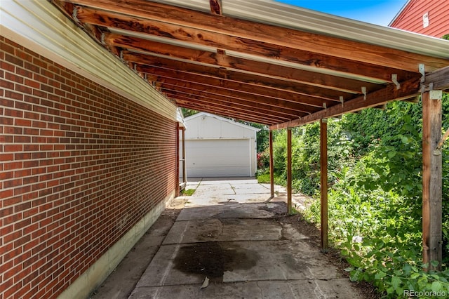 3182 W Radcliff Dr, Englewood, CO 80110 - view of patio with a garage, an outbuilding, and a carport