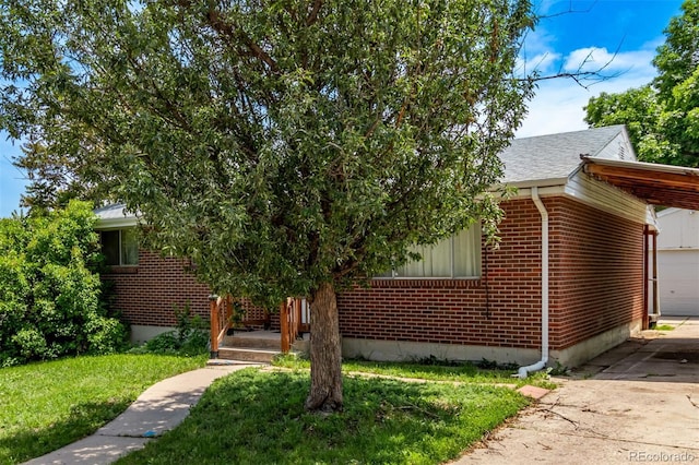 3182 W Radcliff Dr, Englewood, CO 80110 - view of front of house with brick siding, driveway, a front yard, roof with shingles, and a garage