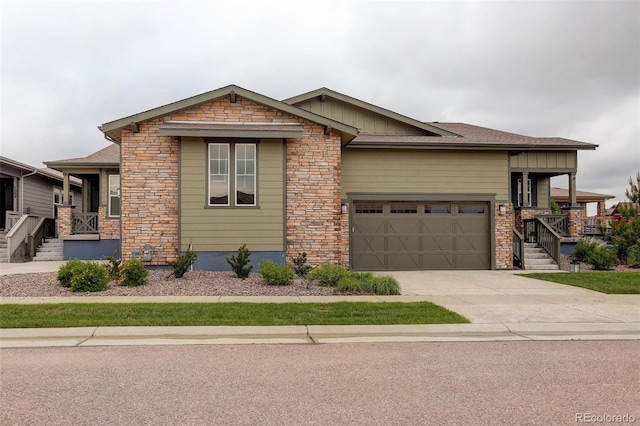 7029 Sagerock St, Castle Pines, CO 80108 - view of front of home with stone siding, driveway, an attached garage, and board and batten siding