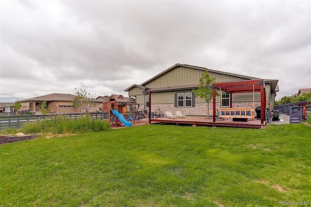 7029 Sagerock St, Castle Pines, CO 80108 - back of house featuring a wooden deck, a playground, stone siding, and board and batten siding