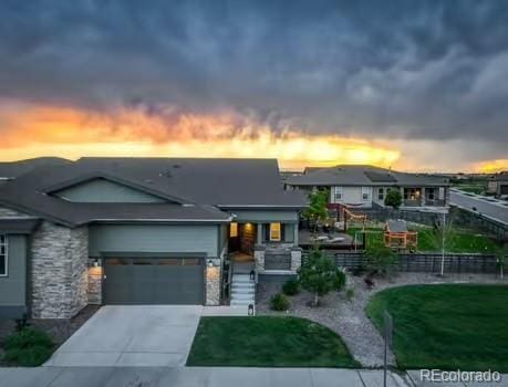 7029 Sagerock St, Castle Pines, CO 80108 - view of front of property with stone siding, concrete driveway, and a garage