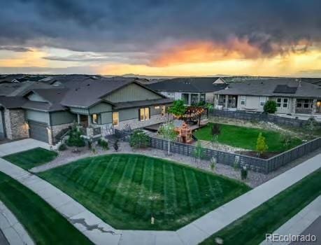 7029 Sagerock St, Castle Pines, CO 80108 - view of back of property at dusk