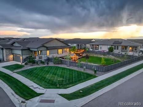 7029 Sagerock St, Castle Pines, CO 80108 - view of front facade with a garage, driveway, and a front yard
