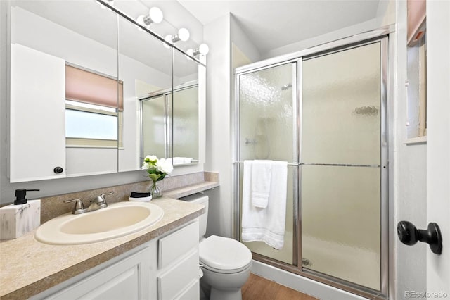6742 Cole Cir, Arvada, CO 80004 - bathroom with vanity, a stall shower, and wood finished floors