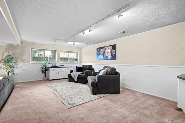 6742 Cole Cir, Arvada, CO 80004 - living room with rail lighting, carpet flooring, and a textured ceiling