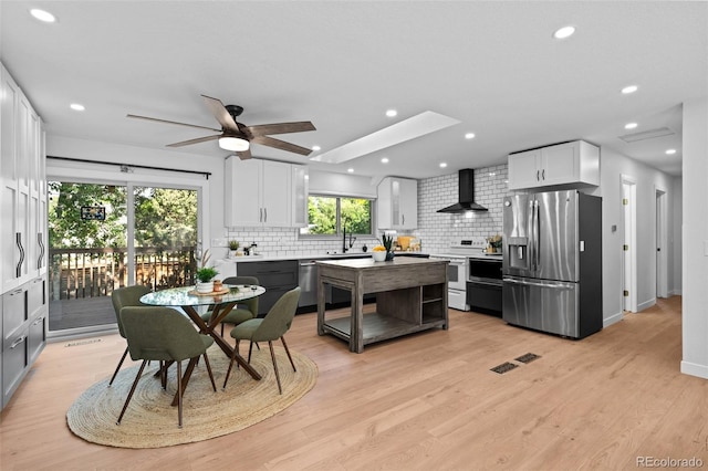 6742 Cole Cir, Arvada, CO 80004 - kitchen with stainless steel appliances, wall chimney range hood, tasteful backsplash, a ceiling fan, and recessed lighting