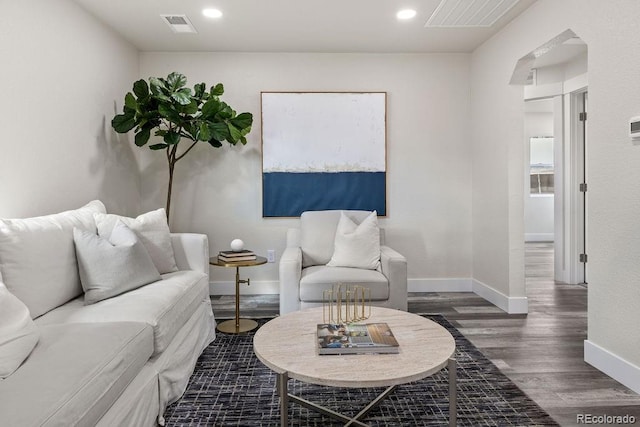 living room with dark hardwood / wood-style flooring