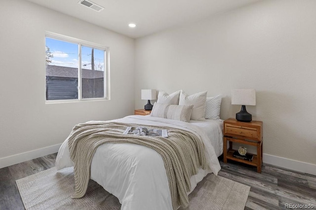 bedroom with dark wood-type flooring