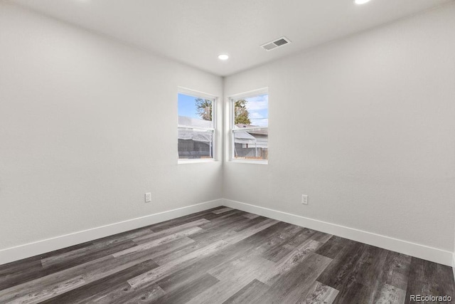 spare room featuring dark hardwood / wood-style floors