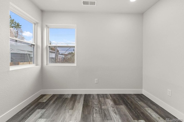 spare room featuring dark hardwood / wood-style floors