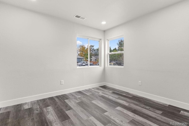 empty room with dark hardwood / wood-style floors