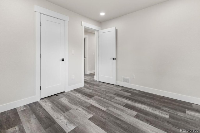 unfurnished bedroom with dark hardwood / wood-style floors