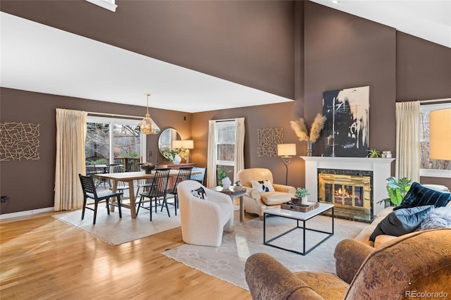 living room with light hardwood / wood-style flooring and a high end fireplace