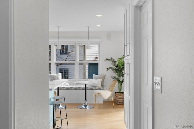 interior space with light wood-type flooring and a brick fireplace