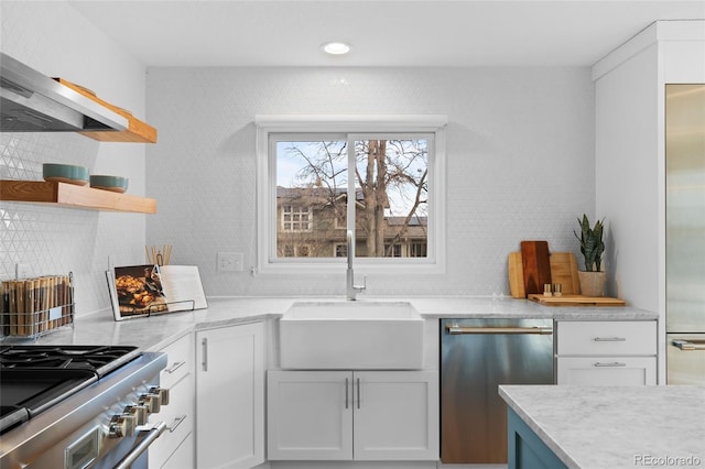 kitchen featuring backsplash, sink, white cabinetry, and stainless steel appliances