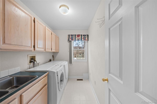 washroom featuring washer and clothes dryer, cabinets, and sink