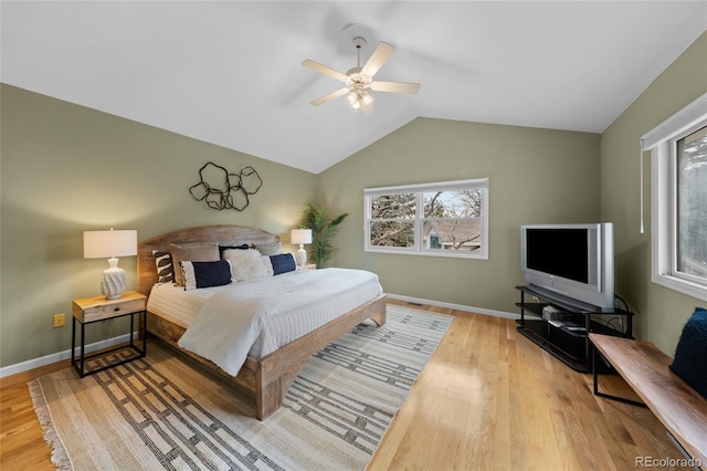 bedroom featuring ceiling fan, light hardwood / wood-style floors, and lofted ceiling