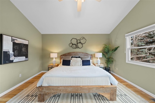 bedroom featuring light wood-type flooring, vaulted ceiling, and ceiling fan