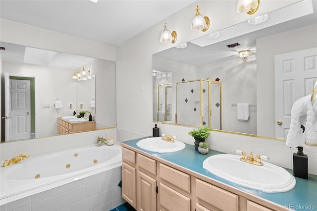 bathroom with vanity and shower with separate bathtub