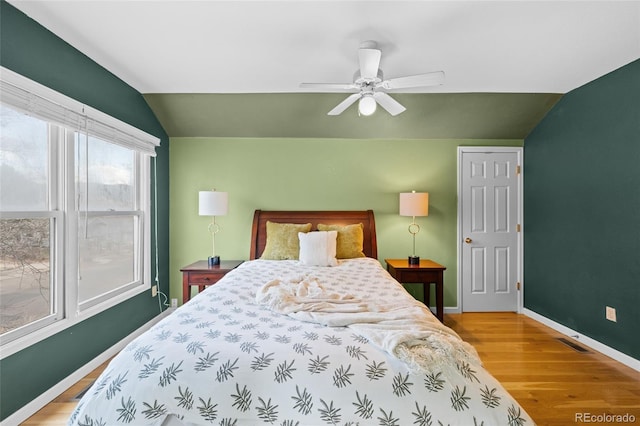 bedroom featuring hardwood / wood-style floors, ceiling fan, and vaulted ceiling