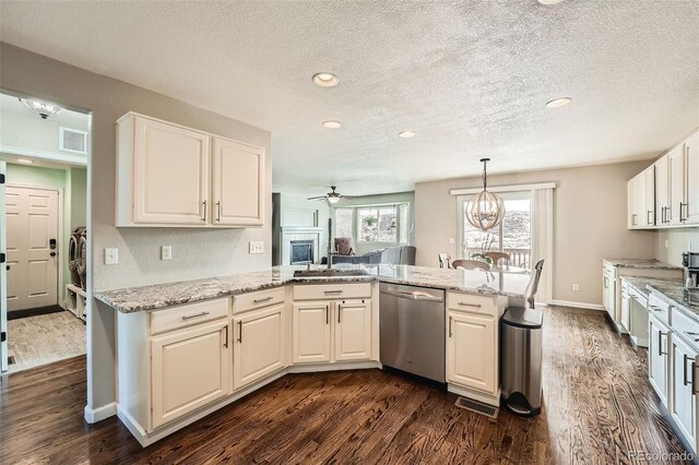 4206 Eagle Ridge Way, Castle Rock, CO 80104 - kitchen featuring dishwasher, dark wood-style flooring, a textured ceiling, a peninsula, and light stone countertops