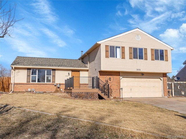 view of front facade featuring concrete driveway, an attached garage, fence, and brick siding