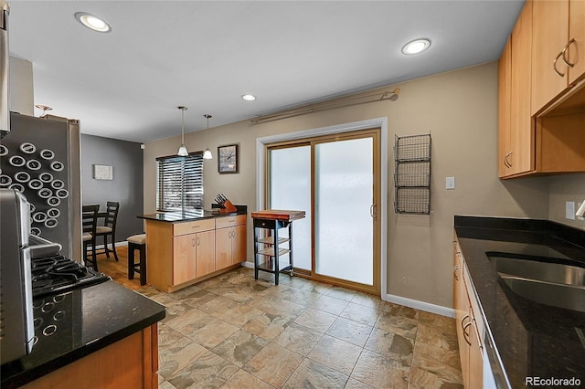 12286 W Tennessee, Lakewood, CO 80228 - kitchen with a peninsula, recessed lighting, decorative light fixtures, dark stone counters, and light stone finish floors