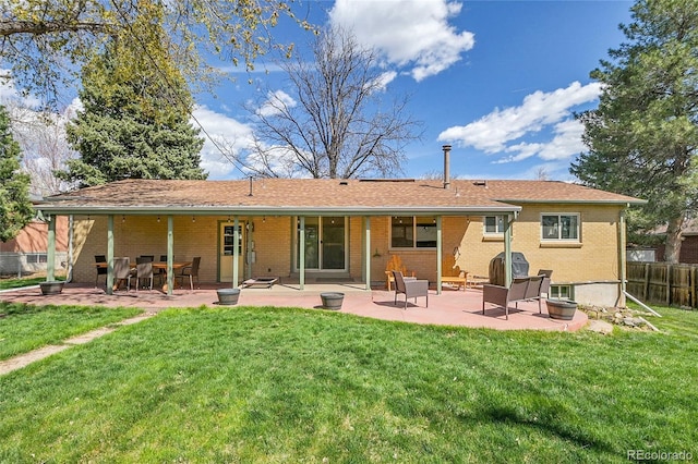 12286 W Tennessee, Lakewood, CO 80228 - rear view of house featuring a patio and brick siding